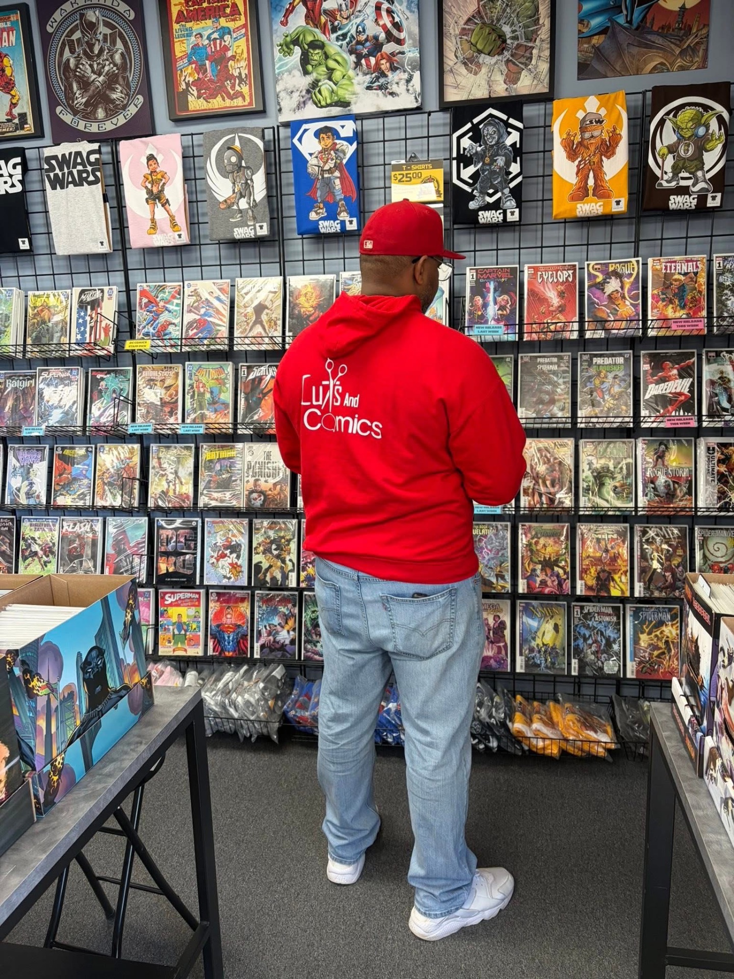 The comic book wall and apparel inside Cuts And Comics